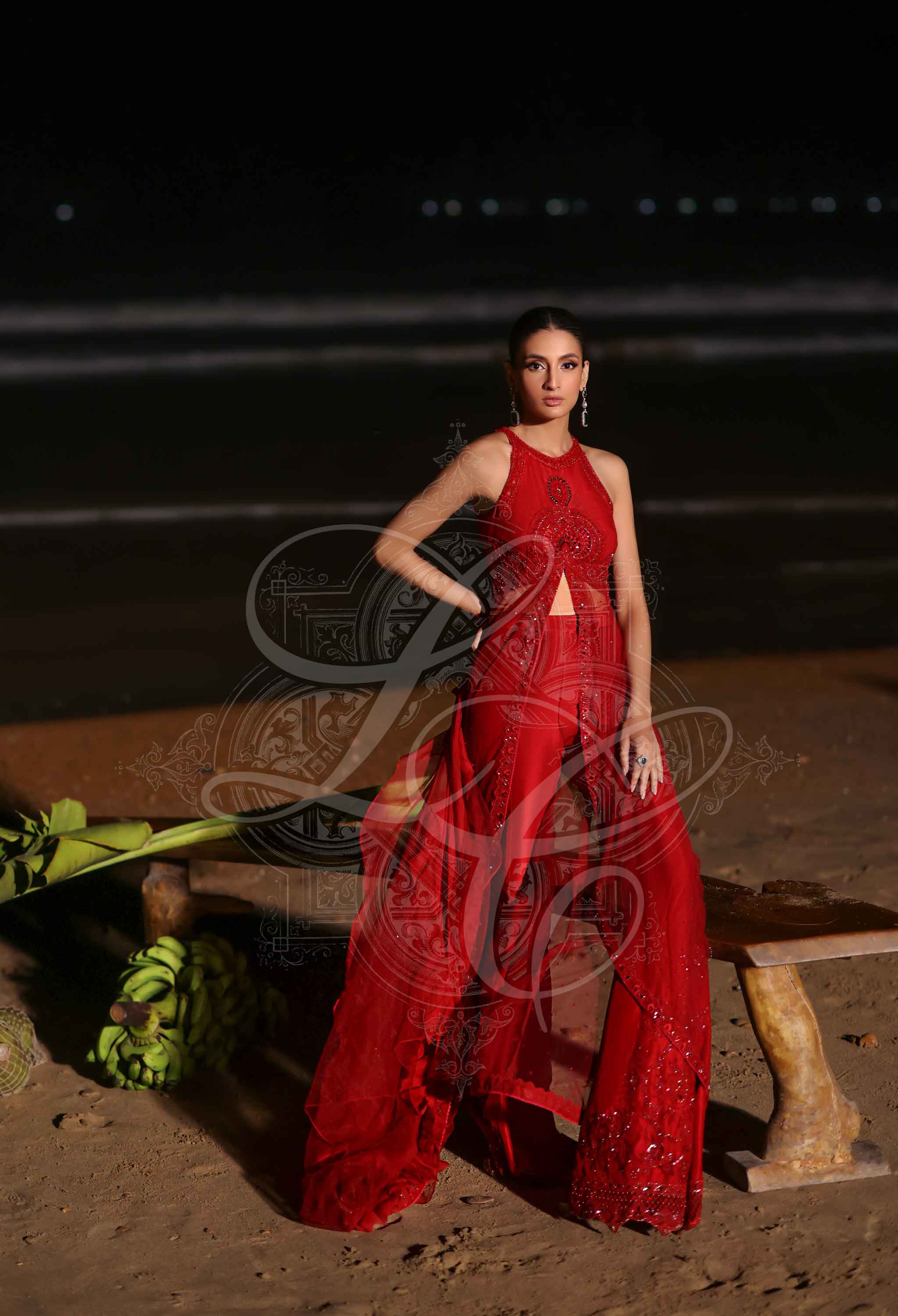 Red embellished draped top with bootcut pants