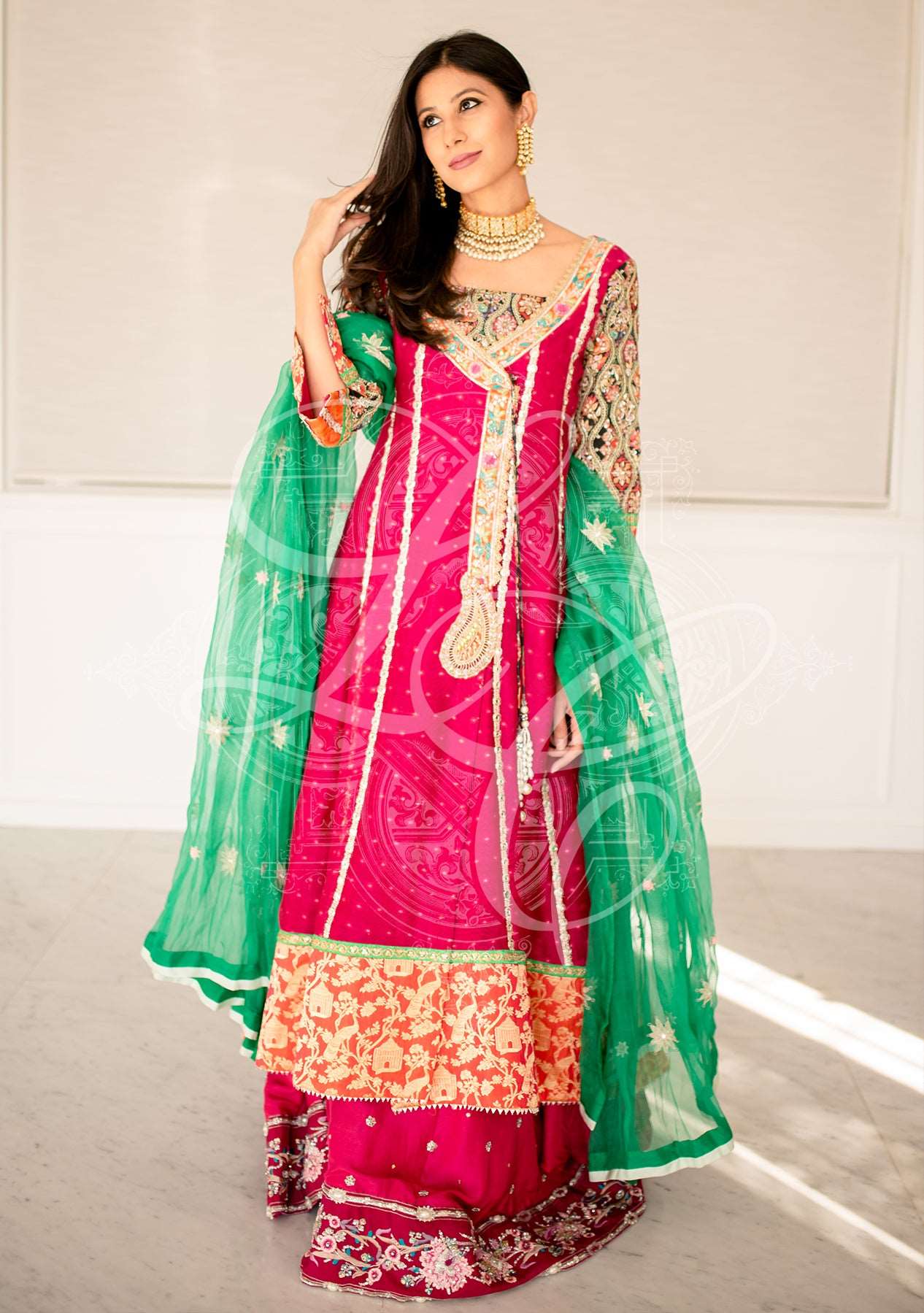 Fuchsia angrakha paired with a gharara and an organza dupatta