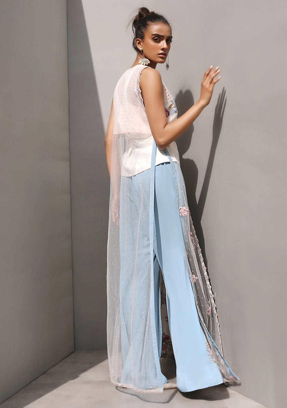 Pink gilet jacket with a cami and bootcut pants