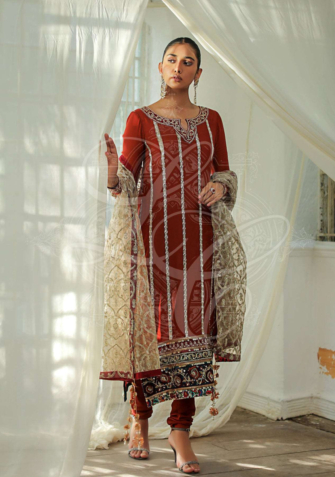 Rust shirt with churidar and gold dupatta