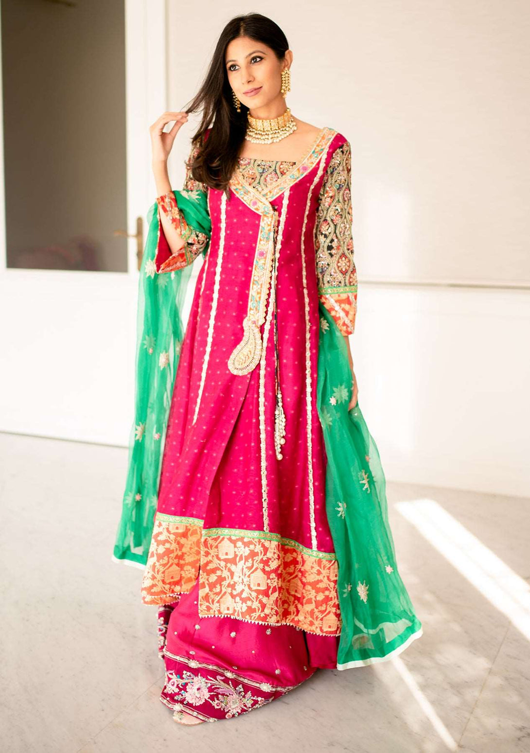 Fuchsia angrakha paired with a gharara and an organza dupatta