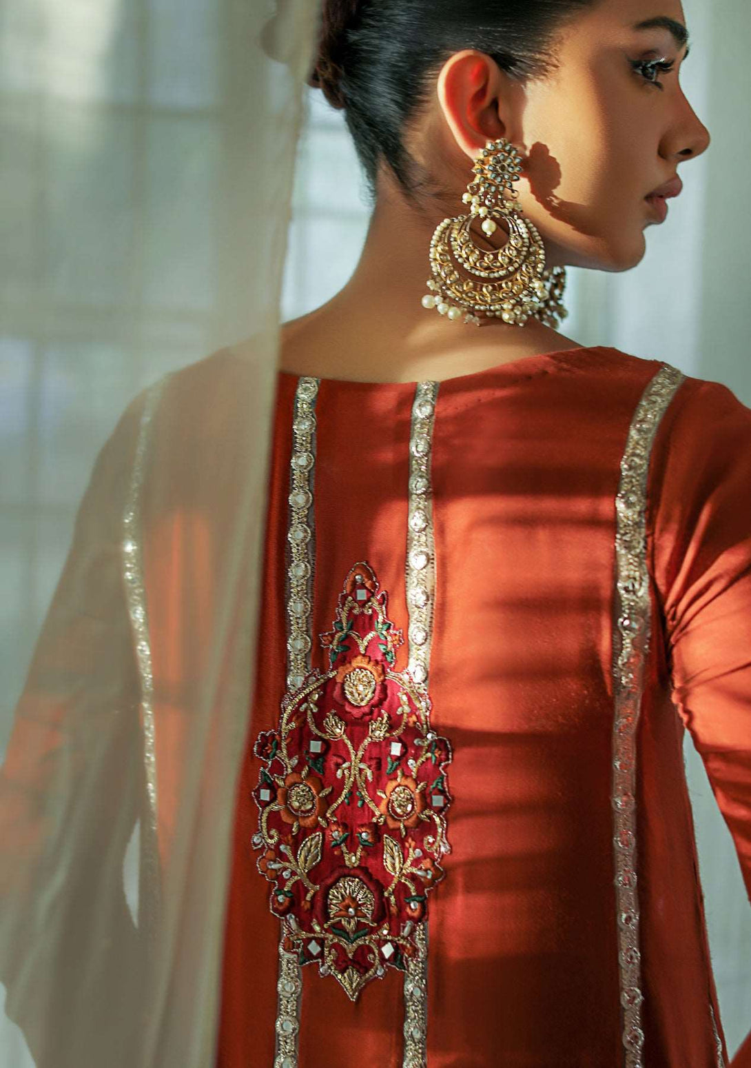 Rust shirt with churidar and gold dupatta